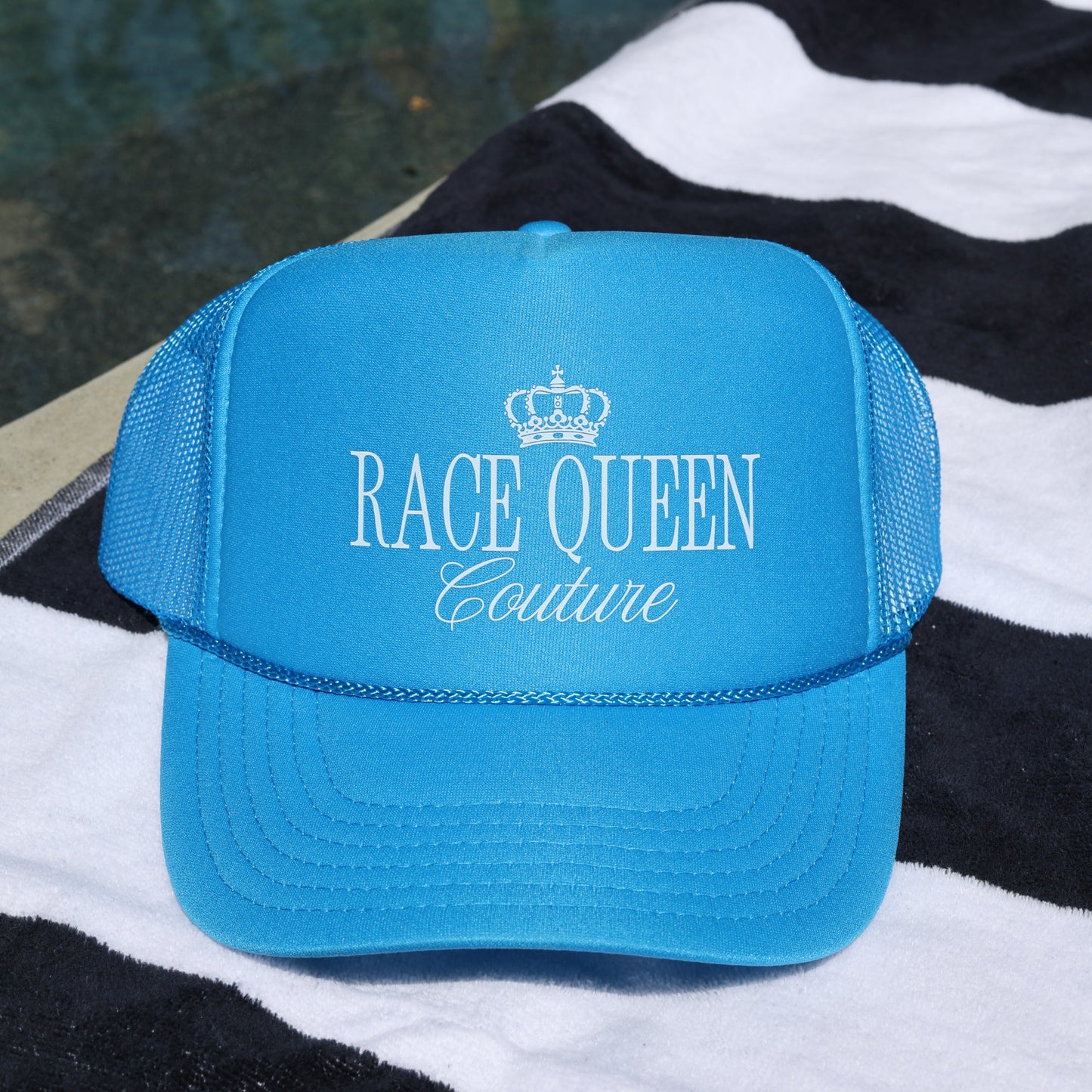 Blue Rqc Trucker Hat on towel