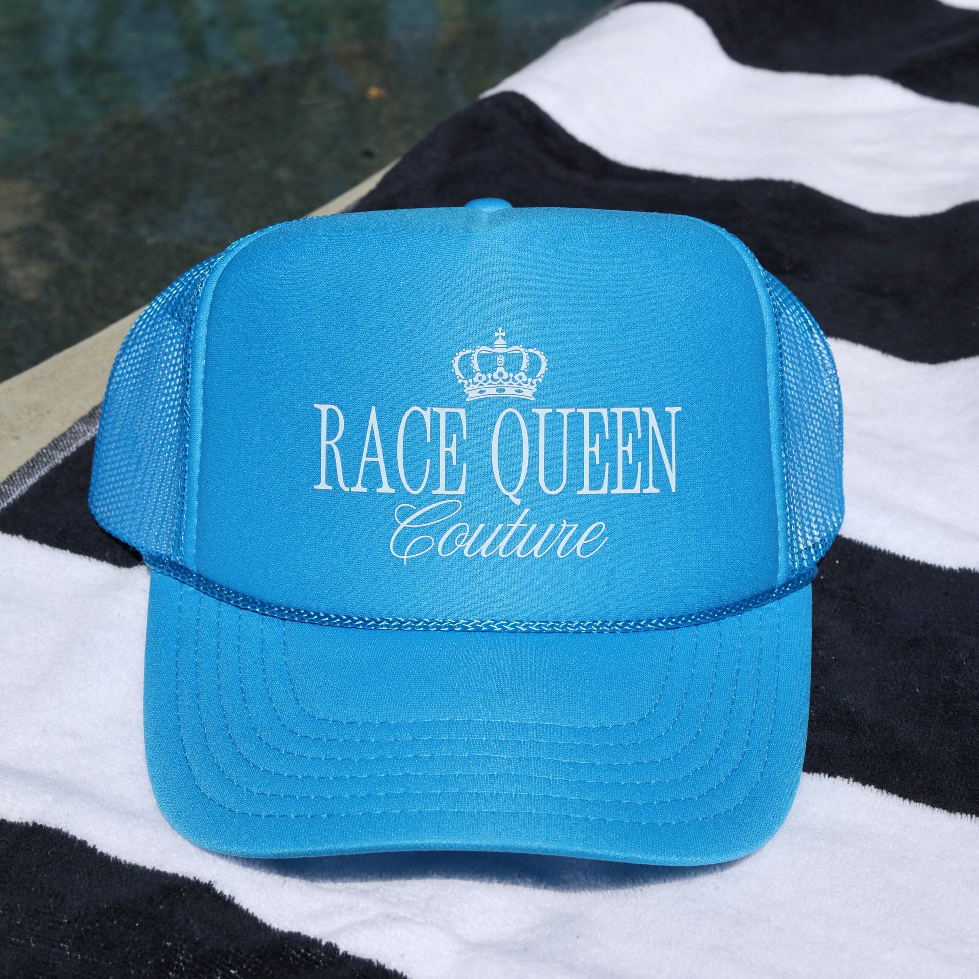 Blue Rqc Trucker Hat on towel