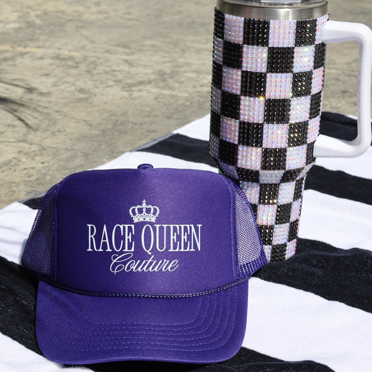 Purple RQC Trucker Hat on towel
