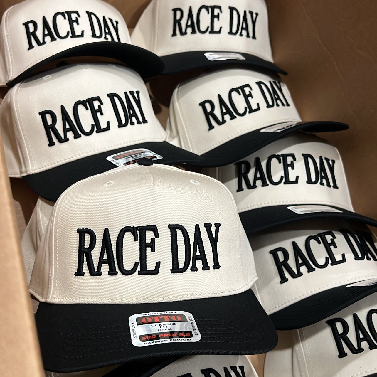 Multiple 'RACE DAY' hats in a box